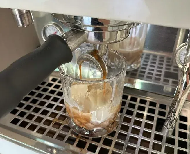 Pouring coffee on ice cream for an affogato